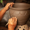Carving a terracotta pot